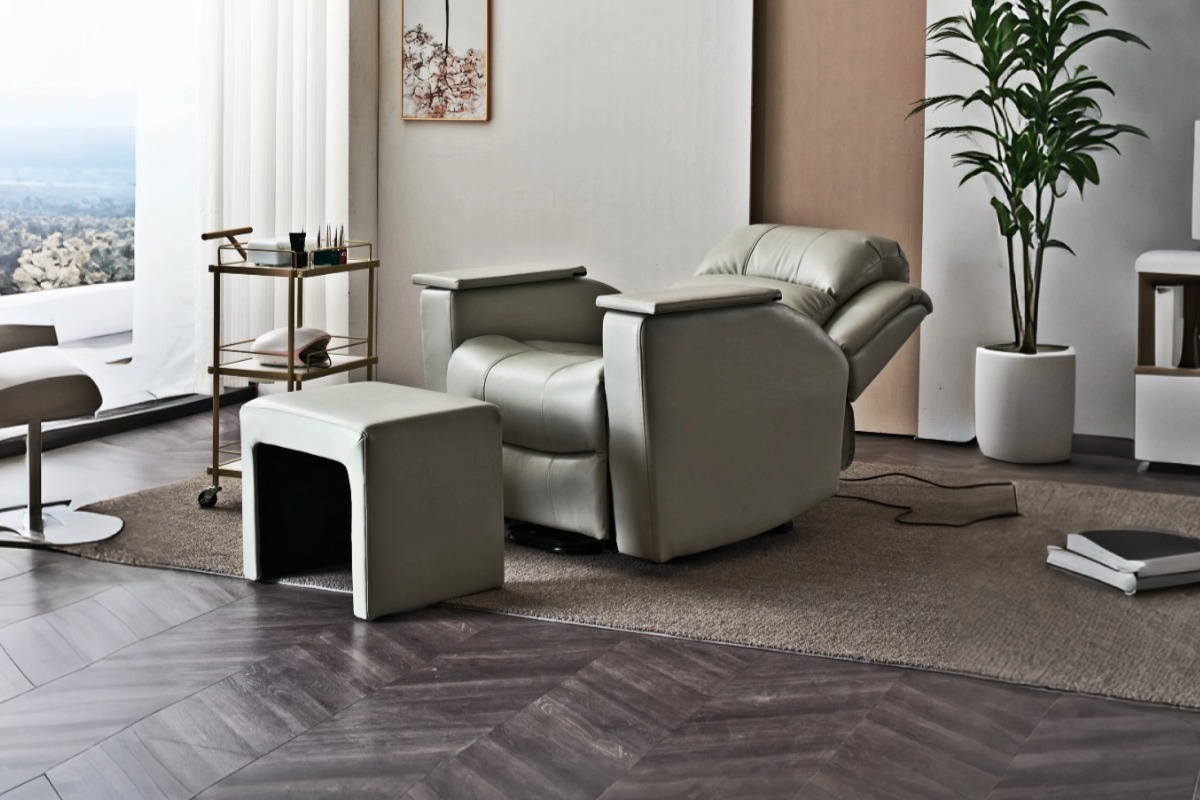 Light grey electric reclining nail spa chair with flip-up armrests, upright position in modern salon Light grey electric reclining nail spa chair with flip-up armrests, upright position in modern salon