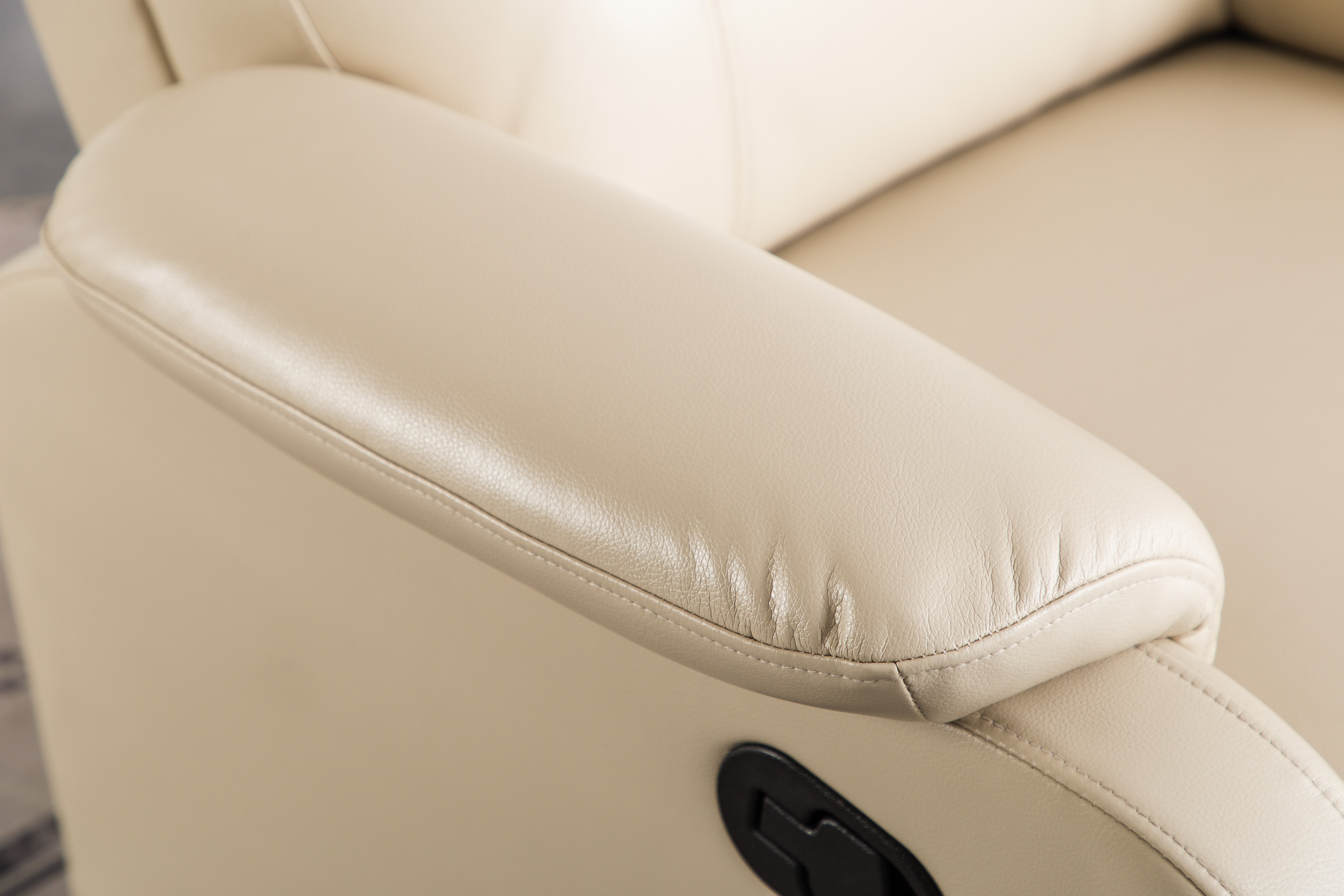 Side view of beige manual recliner chair in upright position, modern design