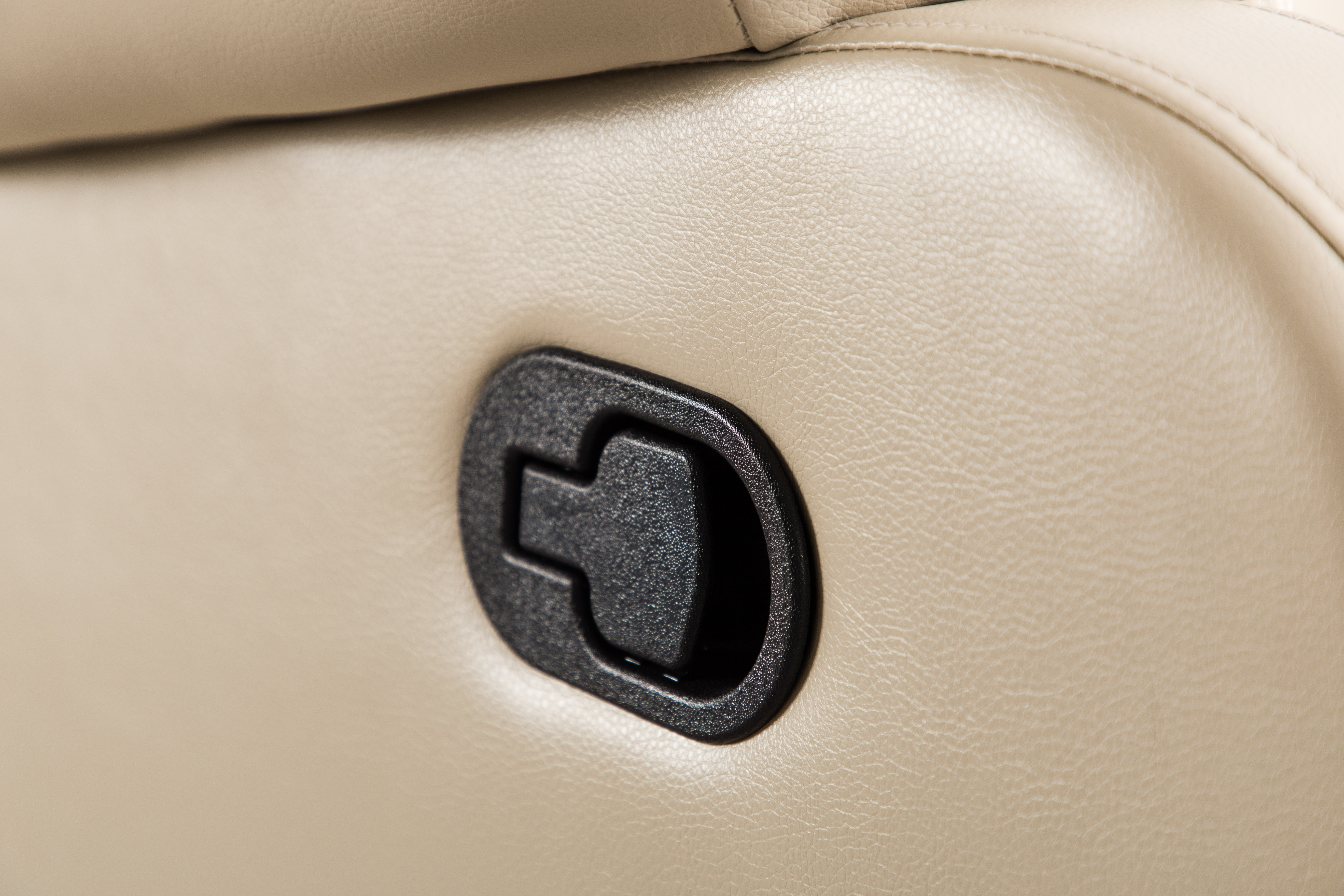 Side view of beige manual recliner chair in upright position, modern design