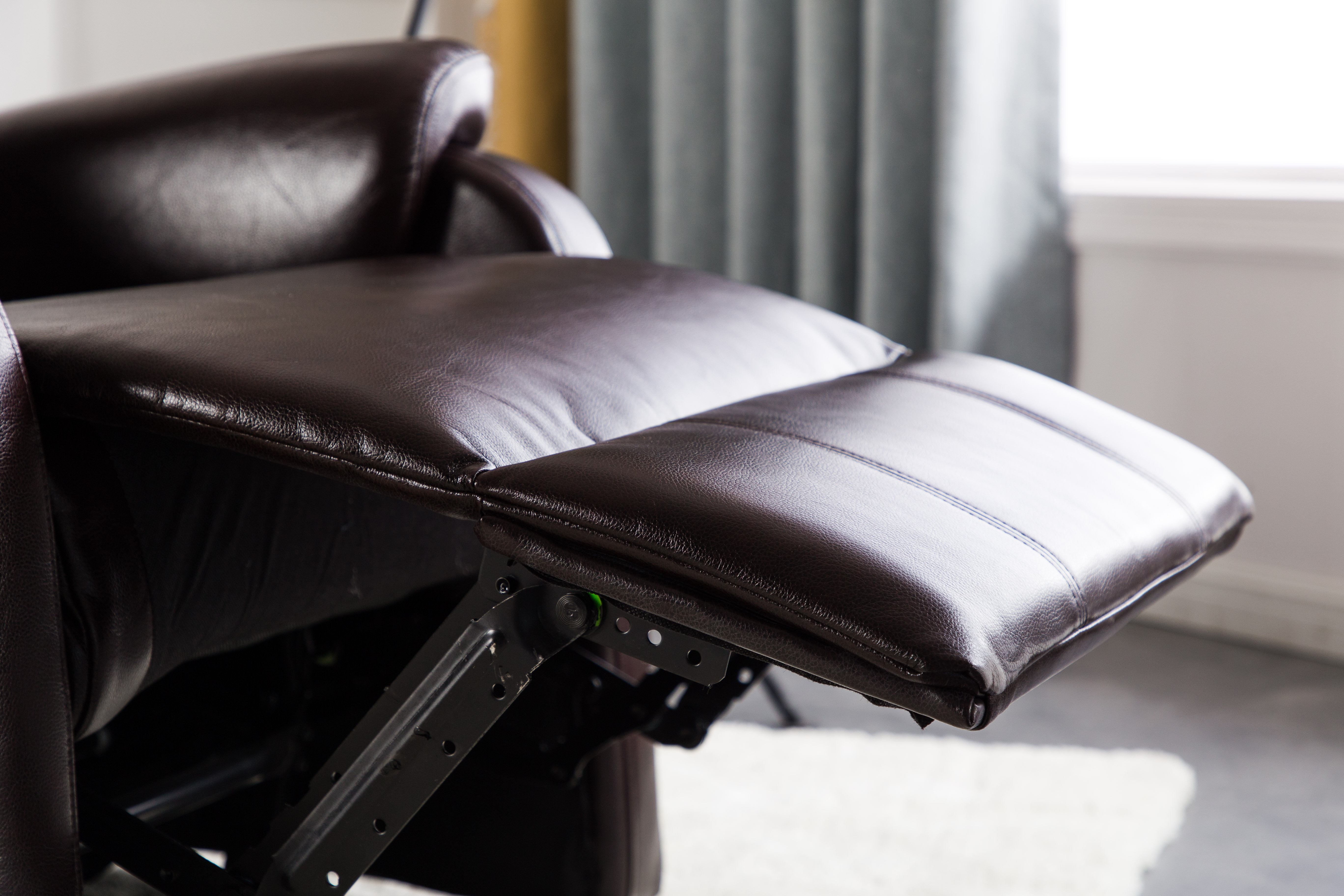 Dark brown manual recliner sofa with convenient side storage pocket